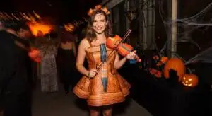 At a lively Halloween party, Violin Vickie steals the spotlight with her enchanting costume.