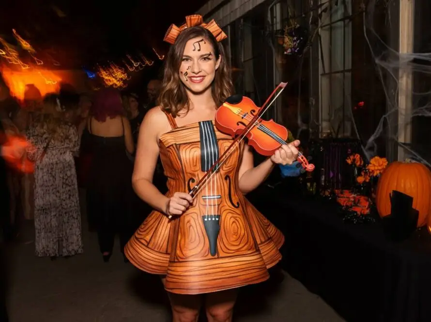 At a lively Halloween party, Violin Vickie steals the spotlight with her enchanting costume.